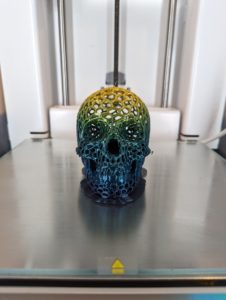 A filigree skull printed in our rainbow filament.
