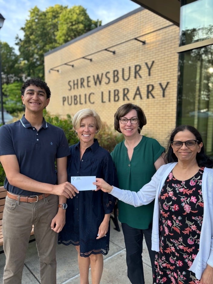Michael Hanna accepting the Friends Scholarship from Chair of the Scholarship Committee, Anne Marie Bird, President of the Board, Vanessa Hale and Director of the Shrewsbury Public Library.